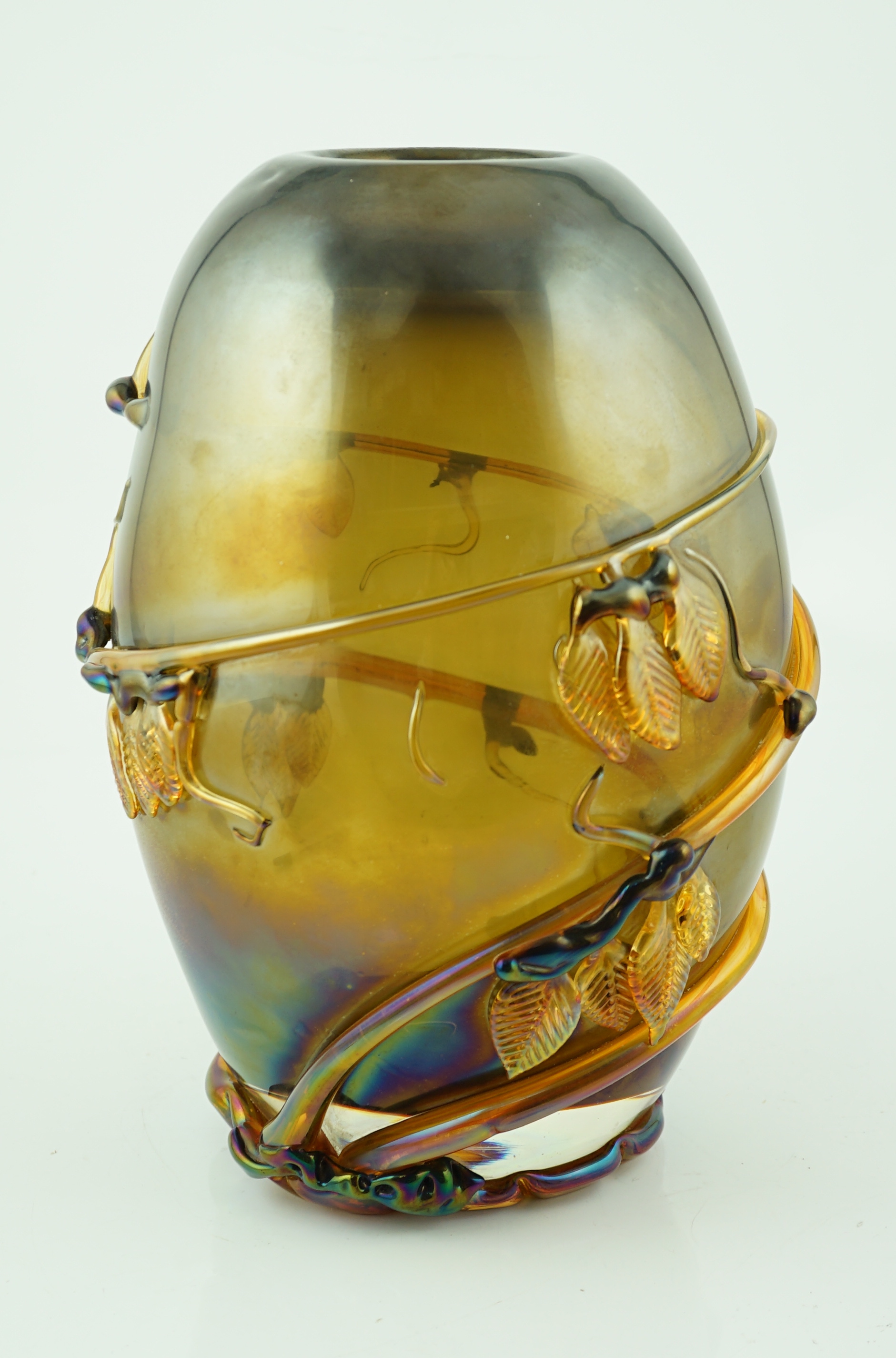A Murano amber glass ovoid shaped vase, entwined with leaves